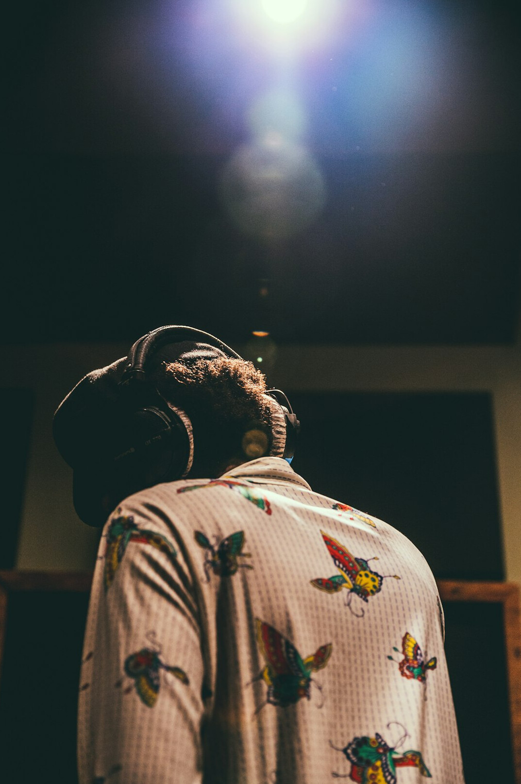 Microphone and headphones in a cosy recording room